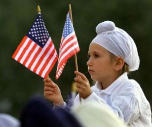 Sikh Kid holding US flags.jpg