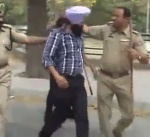 Phase VIII Station House Officer (SHO) Sub-Inspector Kul Bhushan removes the innocent young Sikh's turban - humiliating the Sikh Sangat worldwide