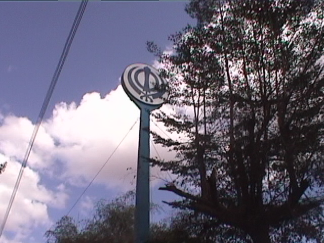 The Khanda sign outside the Gurdwara Sahib. This sign has been here since the earliest days of the Gurdwara. (circa 2002)