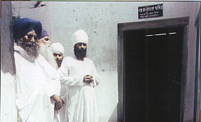 Baba Sukha Singh ji standing with local sangat at the entrance of Gurdwara Maiman Singh..jpg