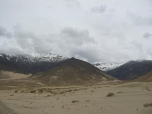 Sand dunes and snowy mountains near Samye Monastery.jpg