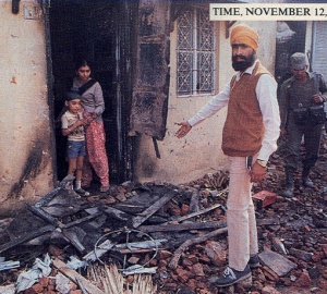 Sikh-showing-burned-property-burning-1984-delhi-mod1.jpg