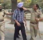 Phase VIII Station House Officer (SHO) Sub-Inspector Kul Bhushan grabs the innocent young Sikh's turban